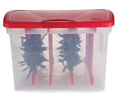 two plastic storage containers with red handles filled with green stringy toys on white background