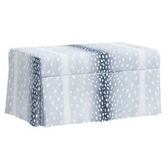 a blue and white polka dot print ottoman cover with ties on it's sides