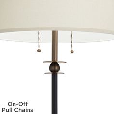 an image of a lamp that is on the floor with chains hanging from it's base