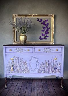 a purple dresser with lavender flowers on it