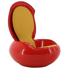 a red bowl with a yellow seat on it