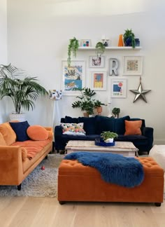 a living room filled with lots of furniture next to a wall covered in pictures and plants