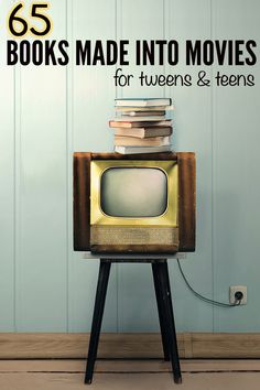 an old tv sitting on top of a wooden stand with books stacked on top of it