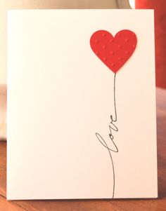 a card with a heart balloon attached to it