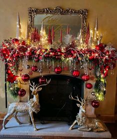 a fireplace decorated with christmas decorations and deer figurines