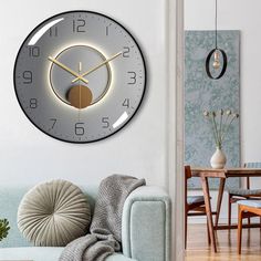 a living room with a couch, table and clock on the wall above it's face