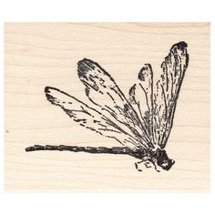 a rubber stamp with a dragonfly on it's back and wings spread out