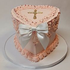 a pink cake with a cross on top