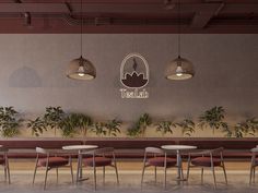 an empty restaurant with tables and chairs in front of a wall that has plants growing on it