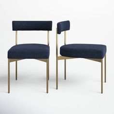 a pair of blue chairs with gold legs and arms, facing each other in front of a white background