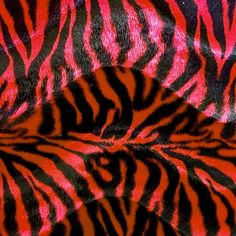 an animal print pattern with red and black stripes on it's fur is shown