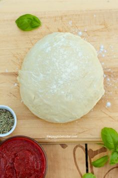 the dough is ready to be made into pizza crusts with basil leaves on top