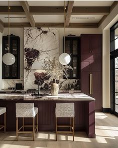 a large kitchen with marble counter tops and dark wood cabinets, along with white stools