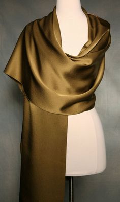 I love the neutrality of this color....a gorgeous bronze hammered silk scarf. It goes with practically everything and needless to say it drapes beautifully.   Silk is a natural fabric and you may notice what you think is an imperfection but it's the nature of the natural fabric.  All of my scarves can be dressed up or down. I finish my scarves with a machine rolled hem.  I am constantly looking for unusual fabrics that would make wonderful scarves. Be nice to your scarves and they will last a lo Luxury Silk Party Shawl, Luxury Fitted Silk Shawl, Luxury Solid Shawl, Luxury Long Dresses In Solid Colors, Luxury Solid Color Shawl Scarf, Elegant Luxury Beige Scarf, Luxury Elegant Beige Scarf, Long Silk Neck Scarf, Luxury Brown Pashmina Shawl