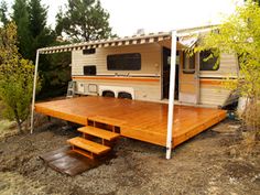 an rv parked on top of a wooden deck