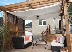 a covered patio area with furniture and an umbrella over the seating area on the deck