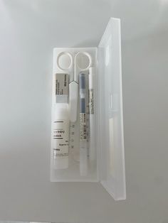 an open plastic container containing several medical items