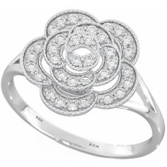 a white gold ring with diamonds in the center and an open flower design on top