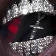 a close up view of a woman's mouth with diamonds on it