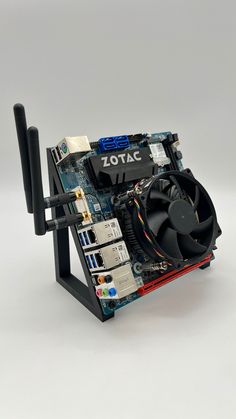 a computer motherboard sitting on top of a metal stand