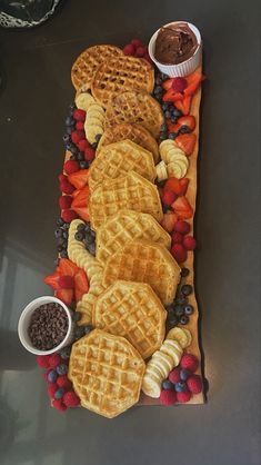 some waffles and fruit are arranged on a table