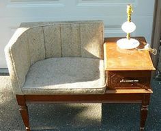 a chair with a lamp on it sitting next to a wooden table in front of a garage door