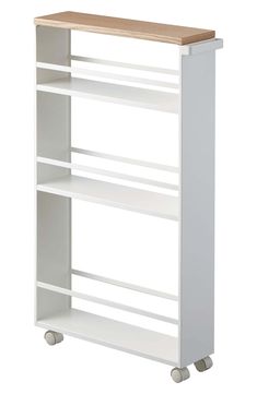 a white bookcase with three shelves on wheels and a wooden top, against a white background