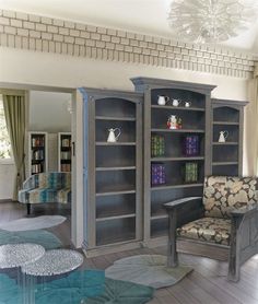 a living room filled with furniture and a book shelf next to a glass top table