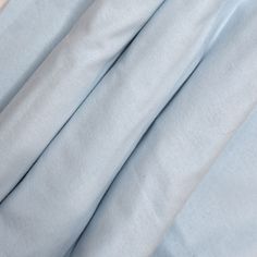 the blue sheets are folded neatly on top of each other in this close up photo