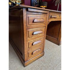 a wooden desk with several drawers on it