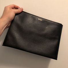 In Great Shape Designer Black Top Handle Pouch, Designer Textured Leather Clutch For Everyday Use, Luxury Black Top Handle Pouch, High-end Black Clutch For Everyday Use, Designer Black Pouch For Everyday, Designer Leather Top Handle Pouch, Modern Black Clutch Pouch, Designer Everyday Pouch Clutch, Designer Top Handle Formal Pouch