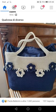 a crocheted bag sitting on top of a wooden table