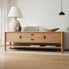 a living room scene with focus on the coffee table and lamp in the foreground