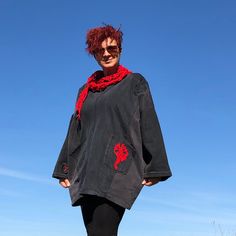 a woman with red hair is standing on a skateboard