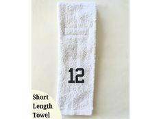 a white towel with the number 12 printed on it and an advertise that reads, short length towel