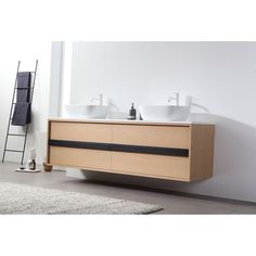 two white sinks sitting on top of a wooden cabinet next to a rug and ladder