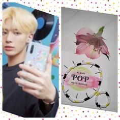 there is a person holding a cell phone in front of a flower and a pop sign