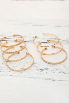 Add some bold flair to your jewelry collection with our Gold 7 pcs Textured Bracelet Set! Each piece features unique textured designs that give off a luxurious and high-end vibe. Perfect for adding a touch of elegance to any outfit. Pre-order now! Material:Alloy Textured Bracelet, Gold Bangle Set, Gold Bracelet Set, Open Bangle, Gold Alloys, Bangle Set, Gold Texture, Gold Bangles, American Style