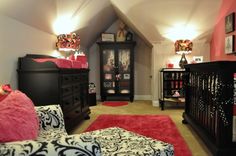 a baby's room is decorated in black and pink with lots of decor on the walls