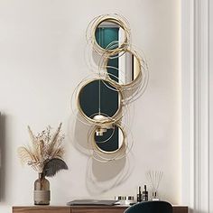 a wall mounted mirror on the side of a white wall next to a desk and chair