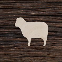 a wooden cutout of a sheep on wood