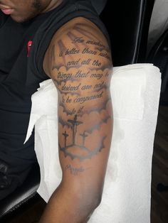 a man with a cross tattoo on his arm