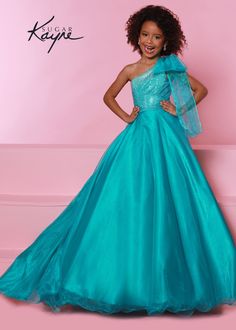 Johnathan Kayne C310 Go ahead and take a BOW in this lovely one-shoulder organza ballgown. The ombre beaded bodice brings all the dazzle! Kids Pageant Dresses Gowns, Crystal Gown, Girls Pageant Gowns, Organza Styles, Kids Pageant Dresses, Pageant Life, Kids Pageant, Organza Overlay, Dress Crystal