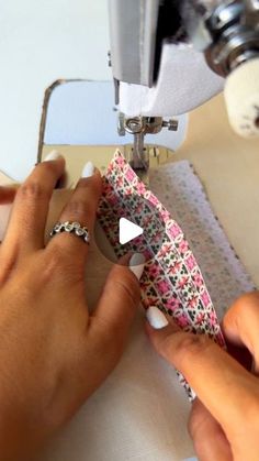 someone is using a sewing machine to sew fabric