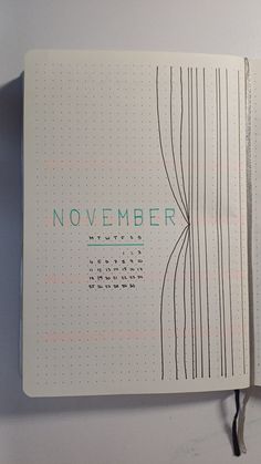 an open notebook with the words november written on it and lines drawn in blue ink