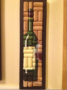 a wine bottle and corks are on the wall next to a glass of wine