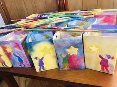 colorful bags with children's drawings on them sitting on a table