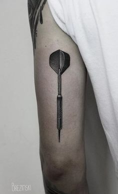 a black and white photo of a golf club tattoo on the left upper half of the arm