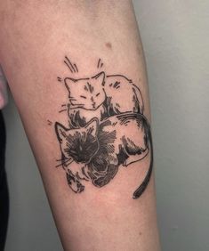 two cats sitting on top of each other in the shape of a flower tattoo design