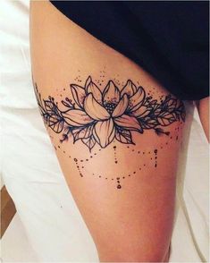 a woman's thigh with a flower tattoo on it